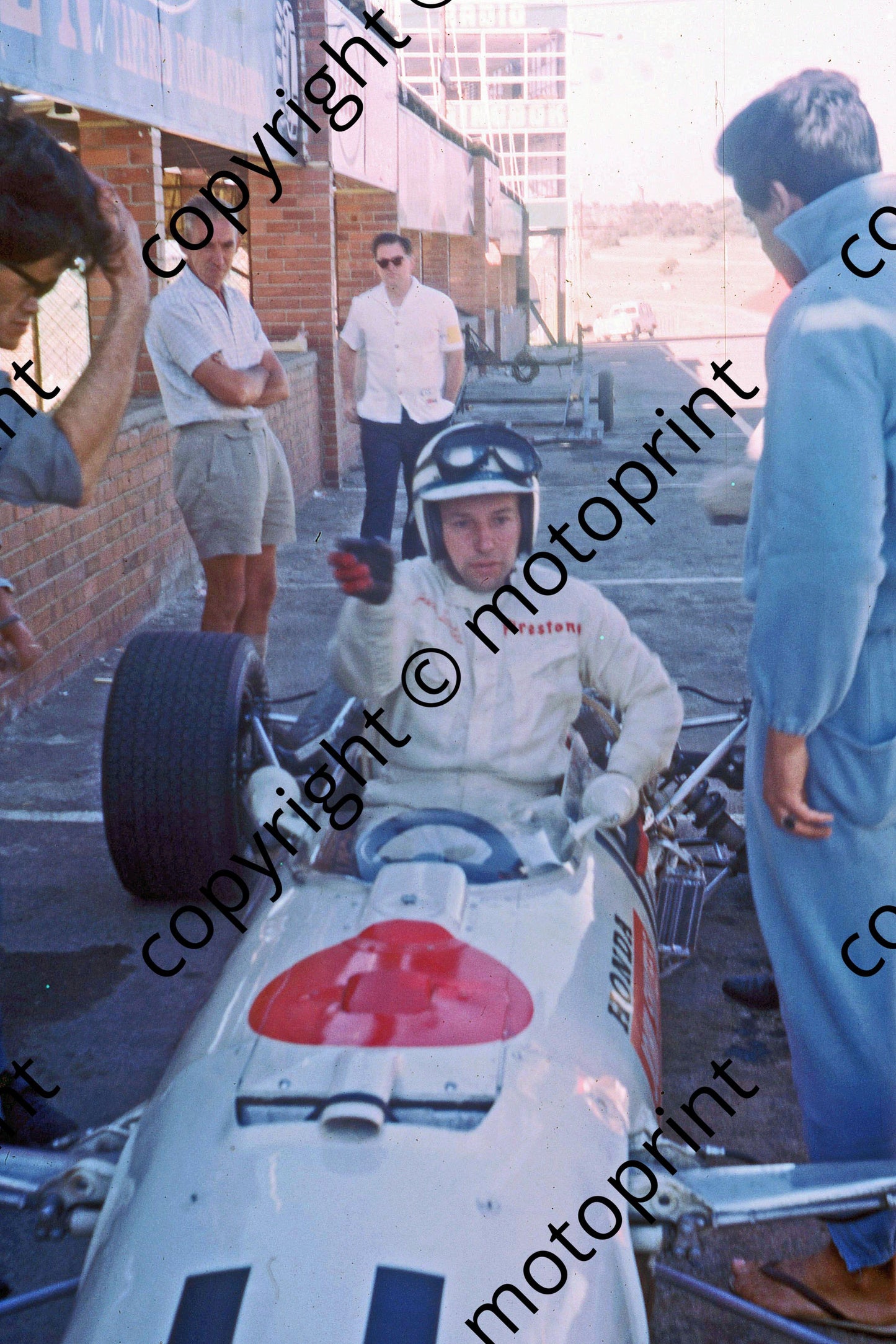 P Surtees in Honda RA273 cockpit practice scanned A4
