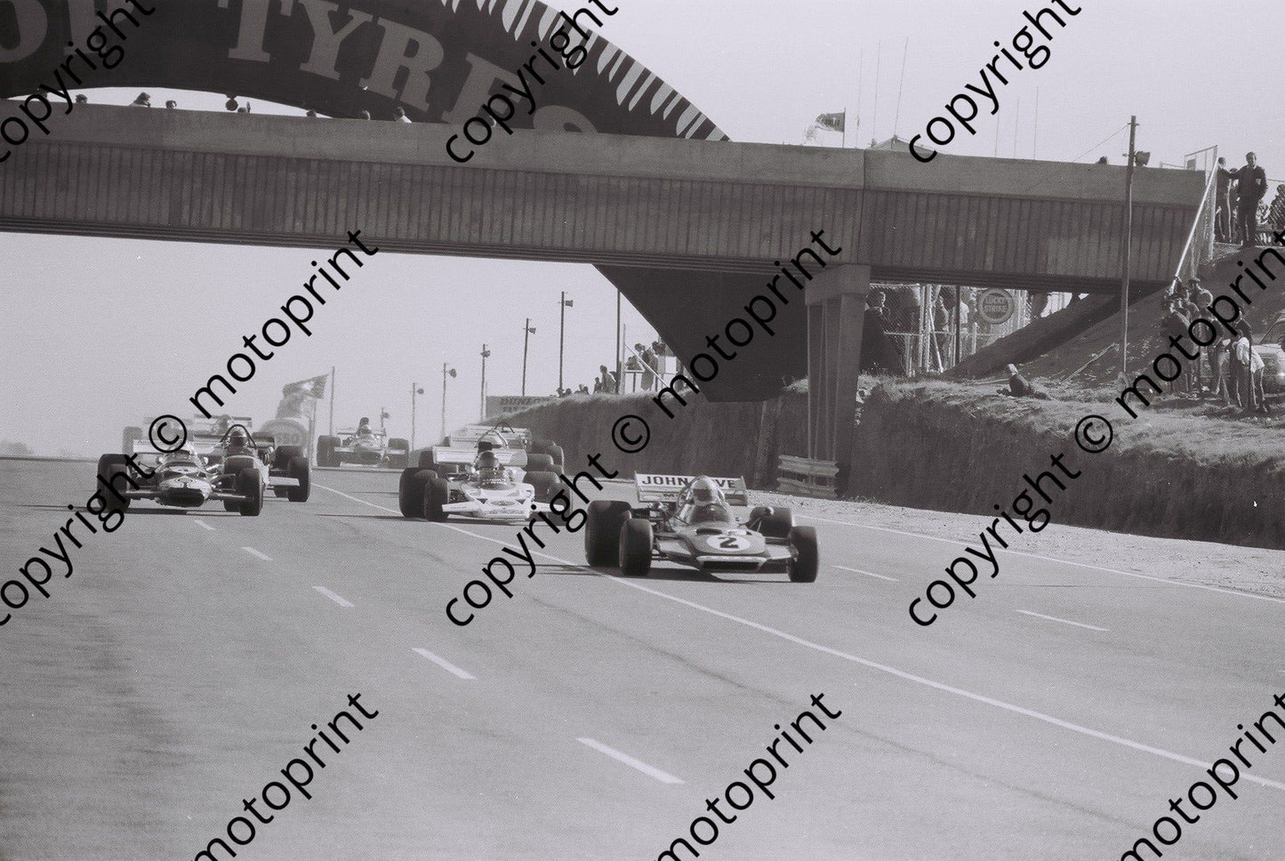 SS 1972 Kyalami start Love Surtees TS9 De Klerl Lotus 49c Charlton Lotus 72 past bridge