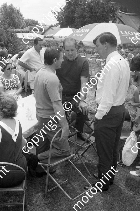 1969 SA GP prizegiving Bruce Denny and Ken, timekeeper John de la Hunt safari suit behind (courtesy Ken Stewart) 122