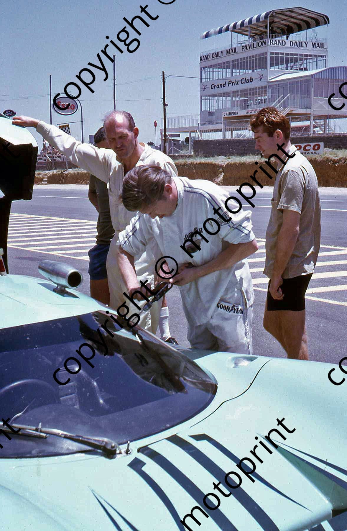 P D'Udy drilling holes, Gardner holds the lid